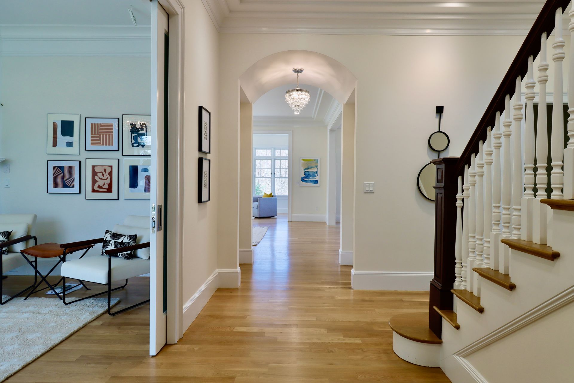 A hallway with stairs leading up to the second floor of a house.