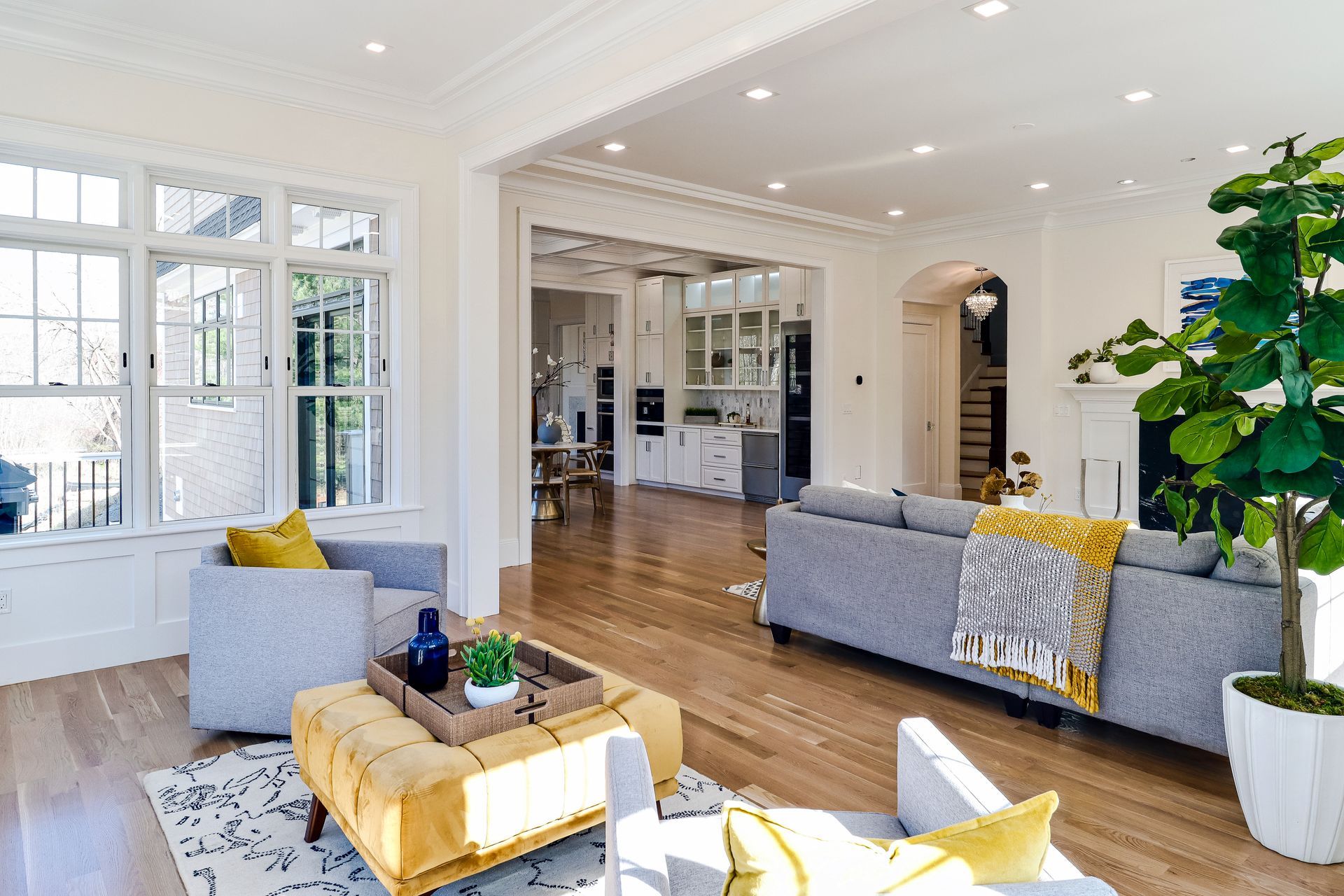 A living room with a couch , chairs , and a coffee table.