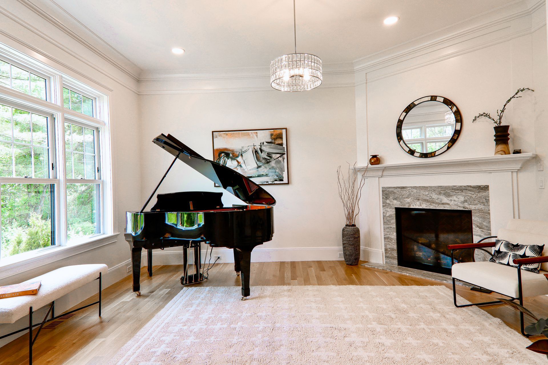 A living room with a piano and a fireplace.