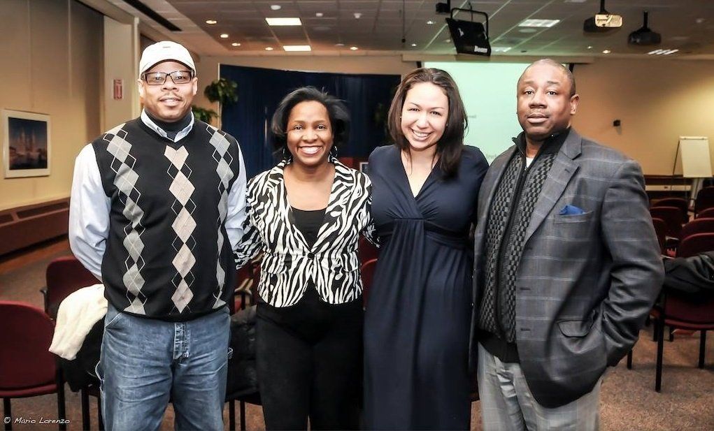 A group of people posing for a picture in a room