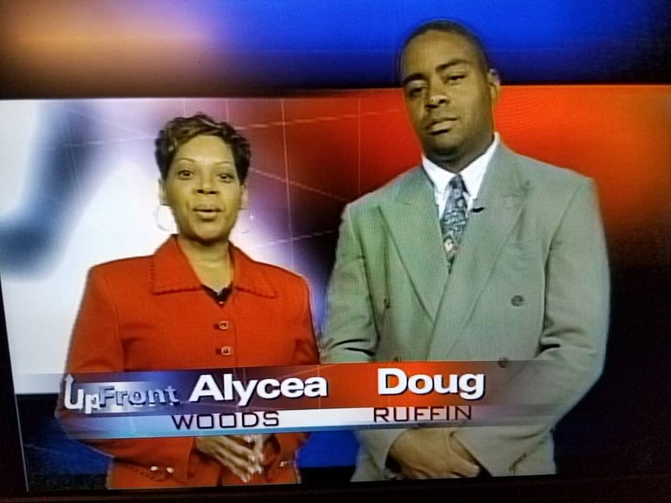 A man and a woman are standing next to each other on a tv screen
