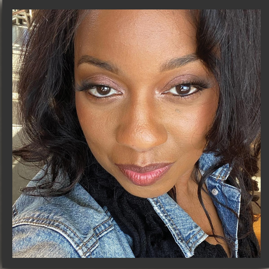 A close up of a woman wearing a denim jacket