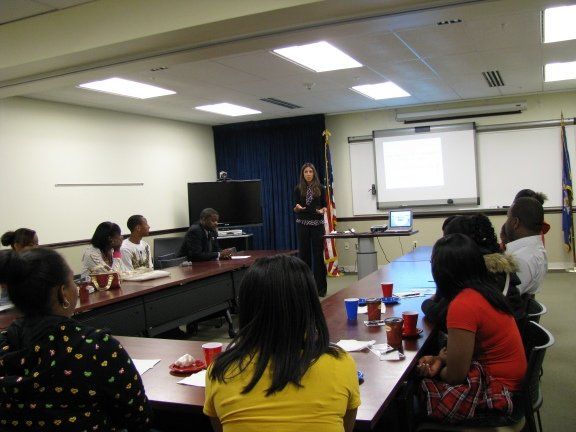 A woman is giving a presentation to a group of people