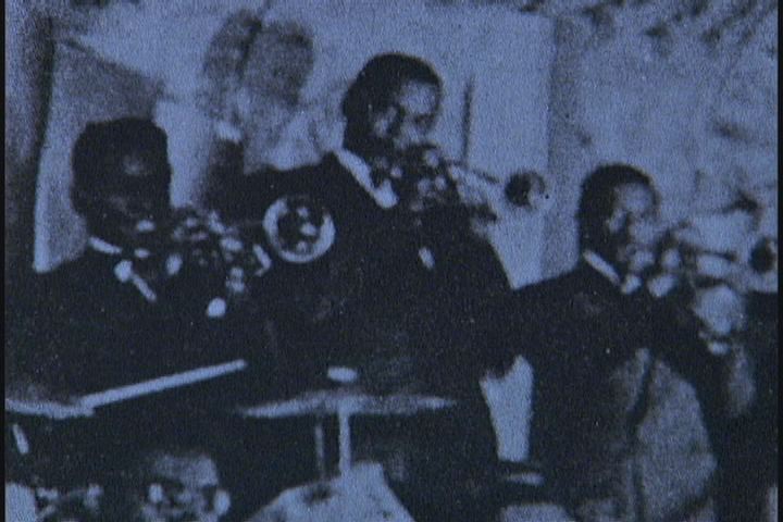 A black and white photo of a band playing instruments