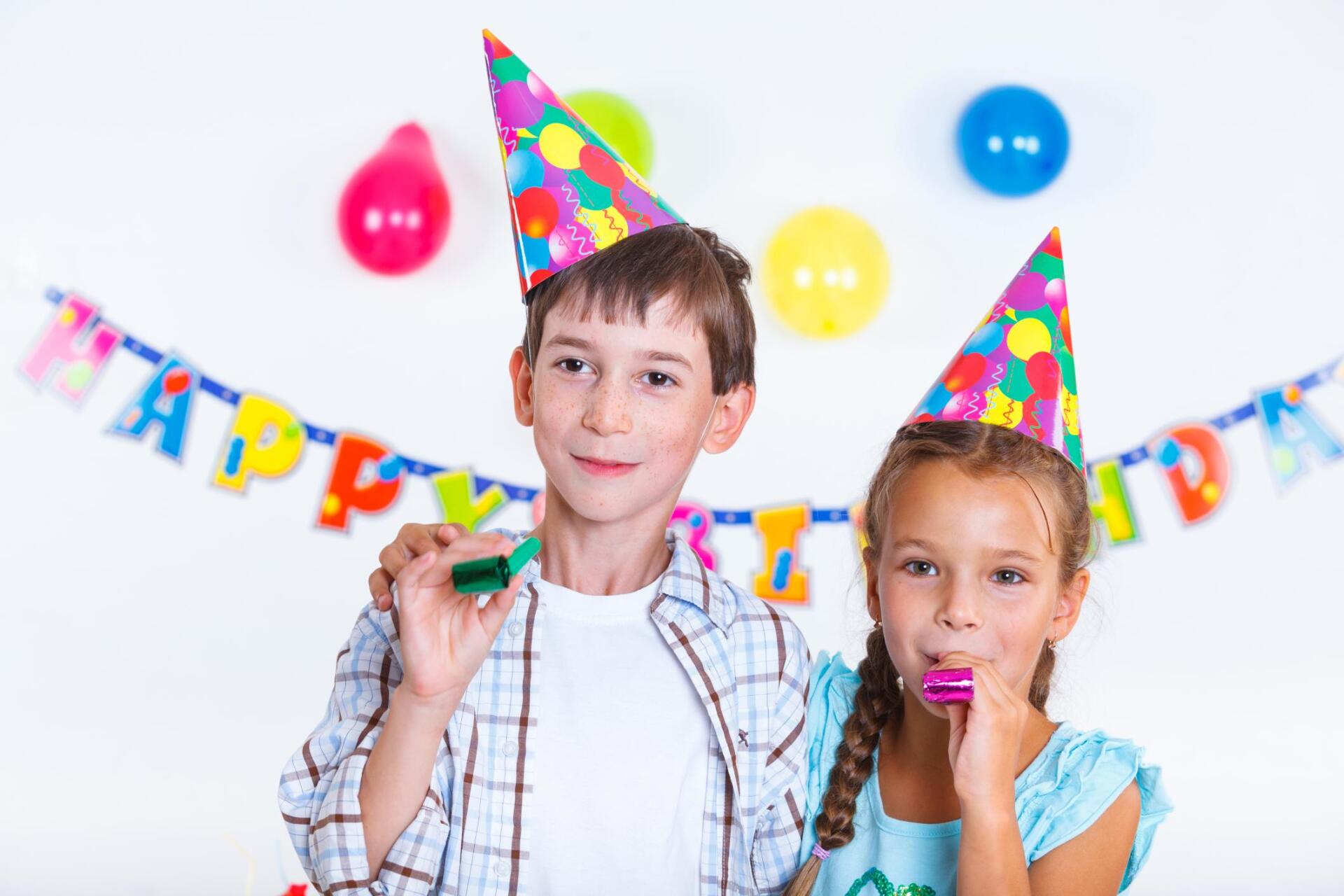 children with colorful party hats