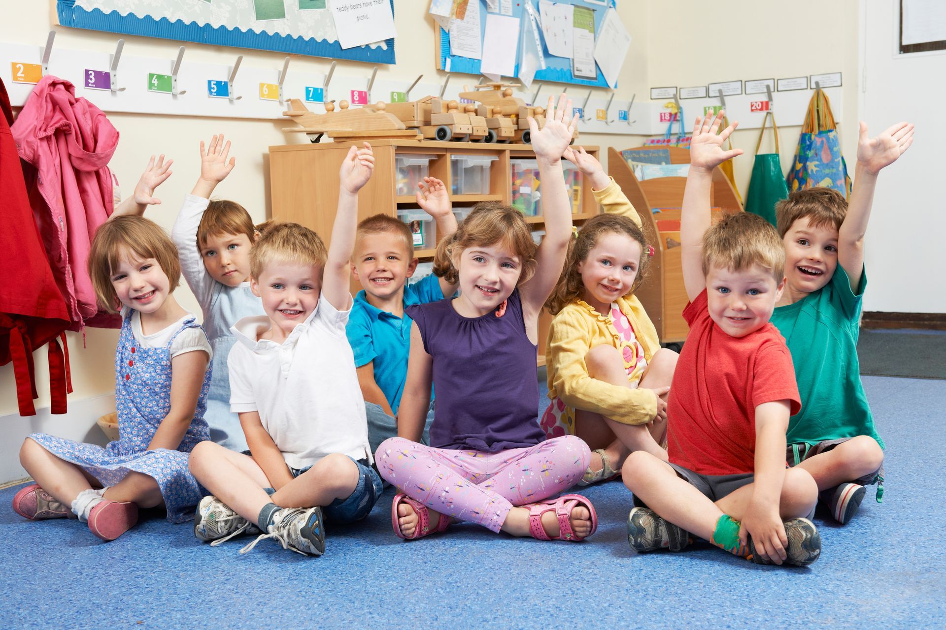 A group of children sitting on the floor | Children's Early Learning Centre