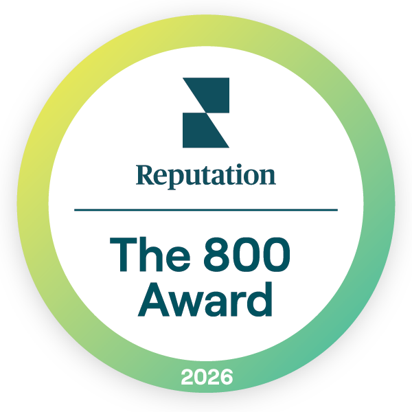 A circular badge with a green and yellow gradient border featuring the text 