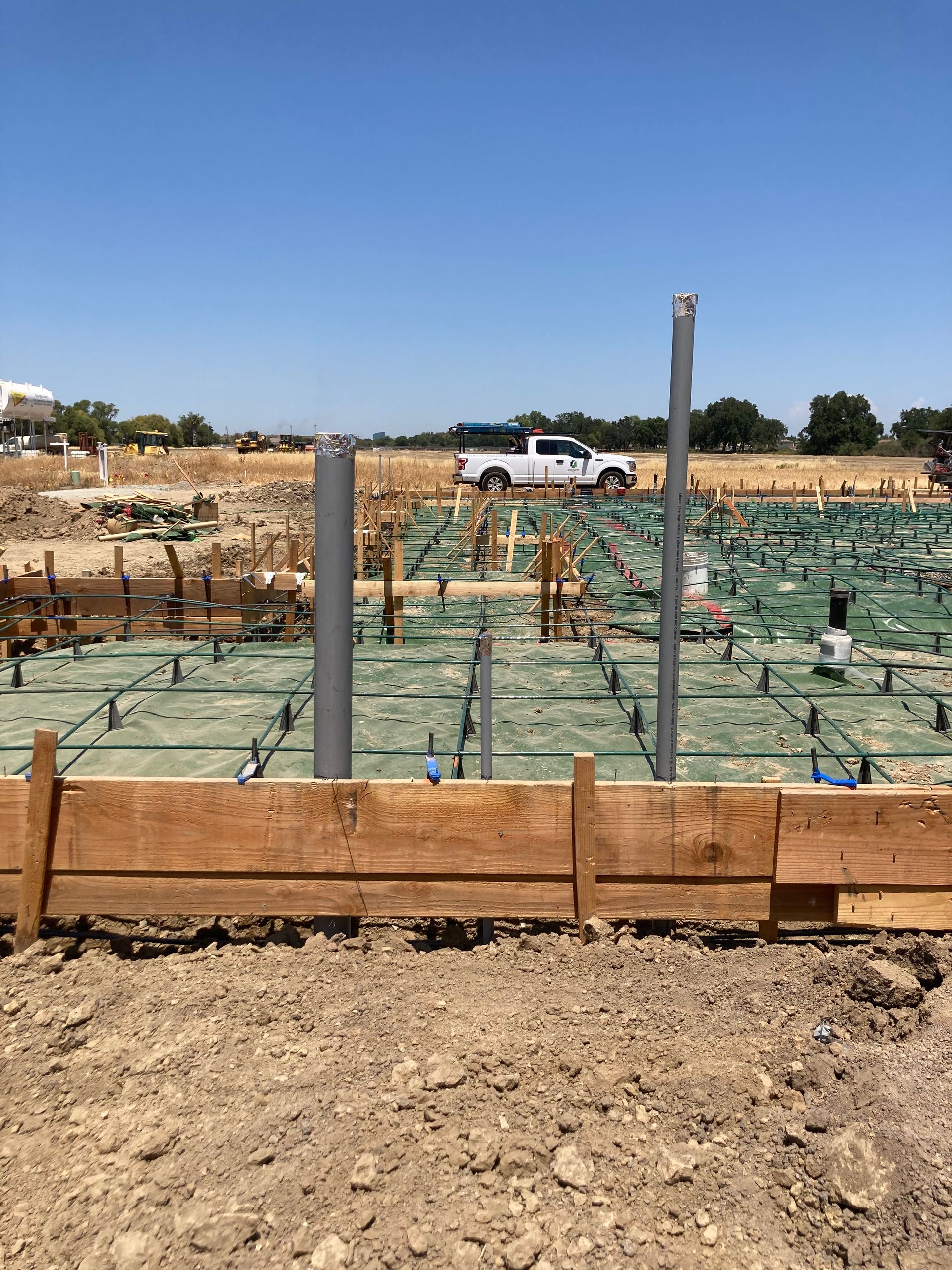 A construction site with a truck parked in the background.