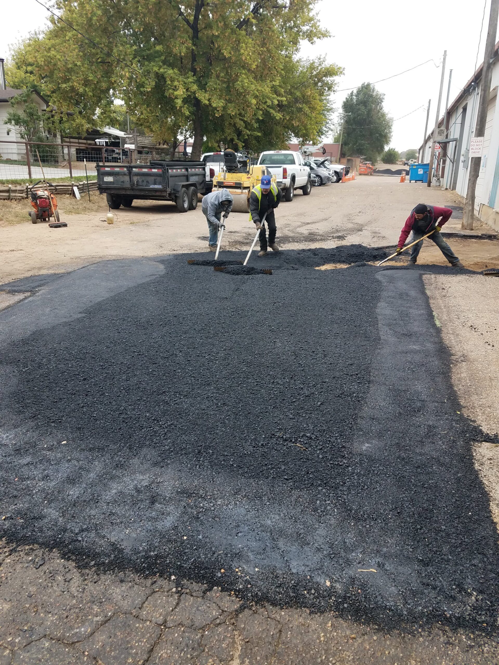 A group of people are working on a road.