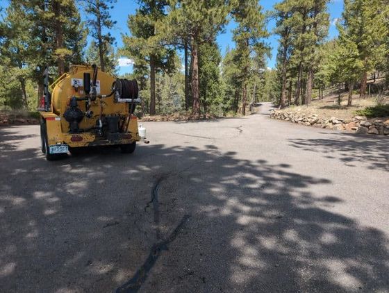 A yellow truck is parked on the side of a road
