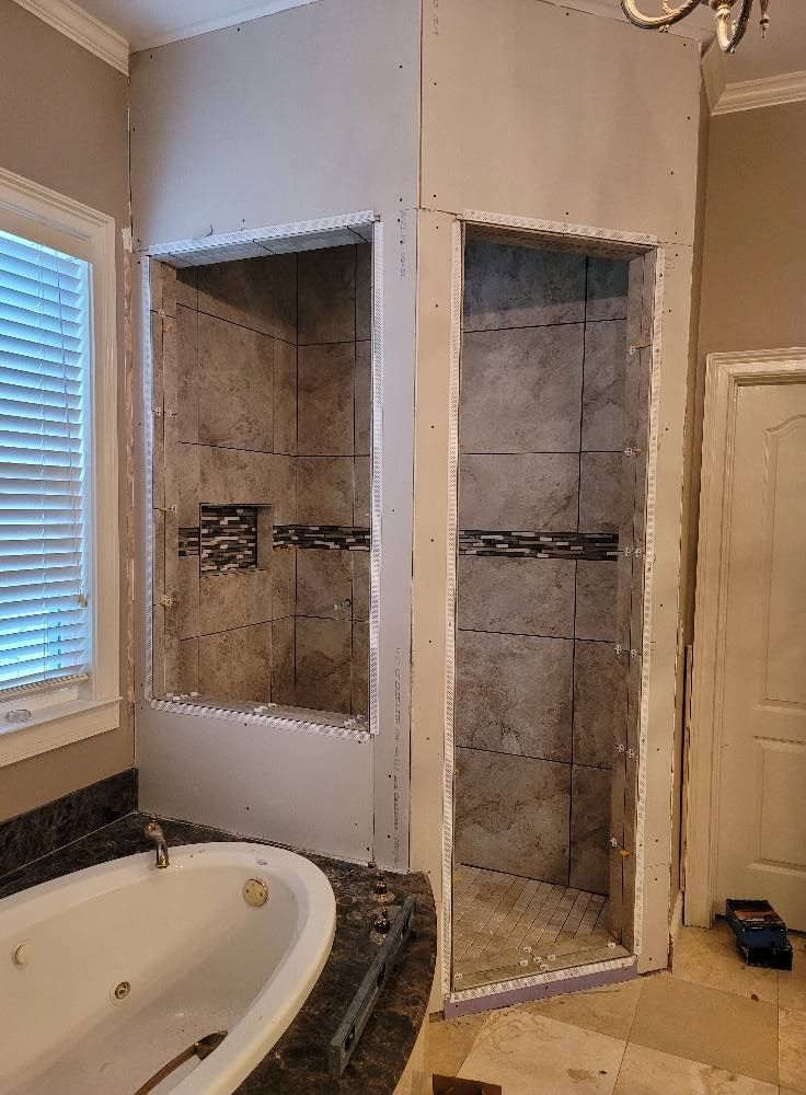 A bathroom with a tub , sink and shower being remodeled.