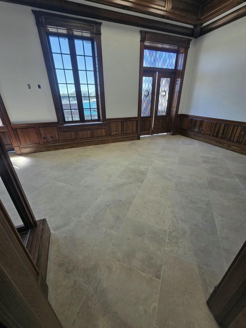 An empty room with a lot of windows and wood paneling