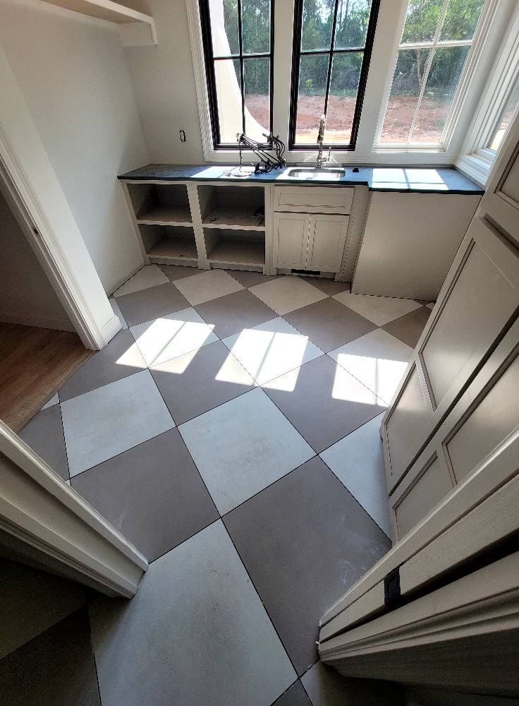 A kitchen with a checkered floor and a sink.