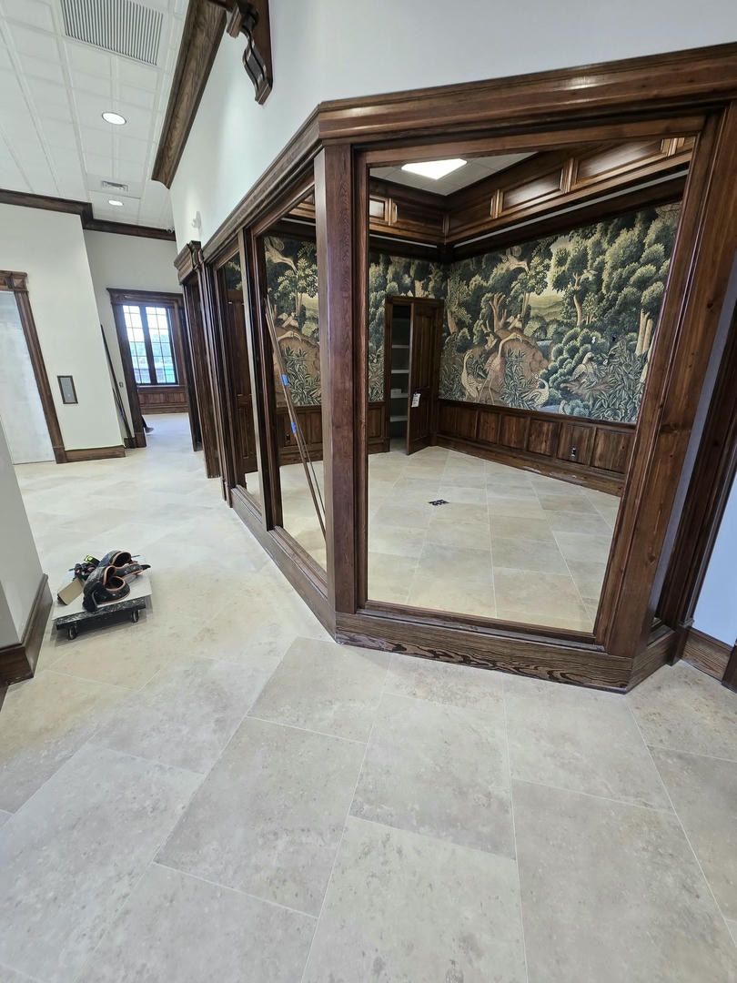 A room with a lot of mirrors and a ladder on the floor.