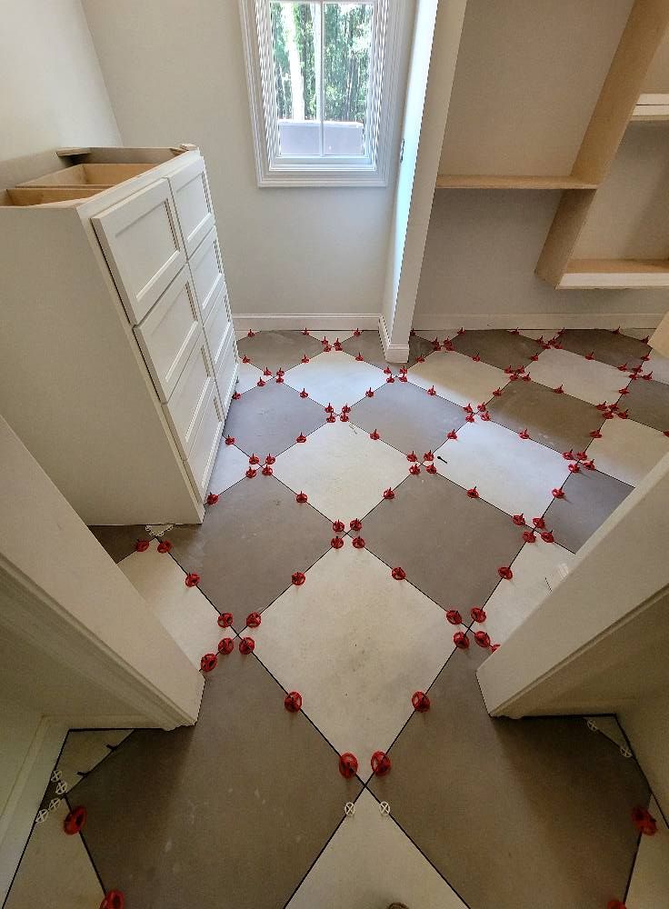 A closet with a checkered tile floor and a dresser.
