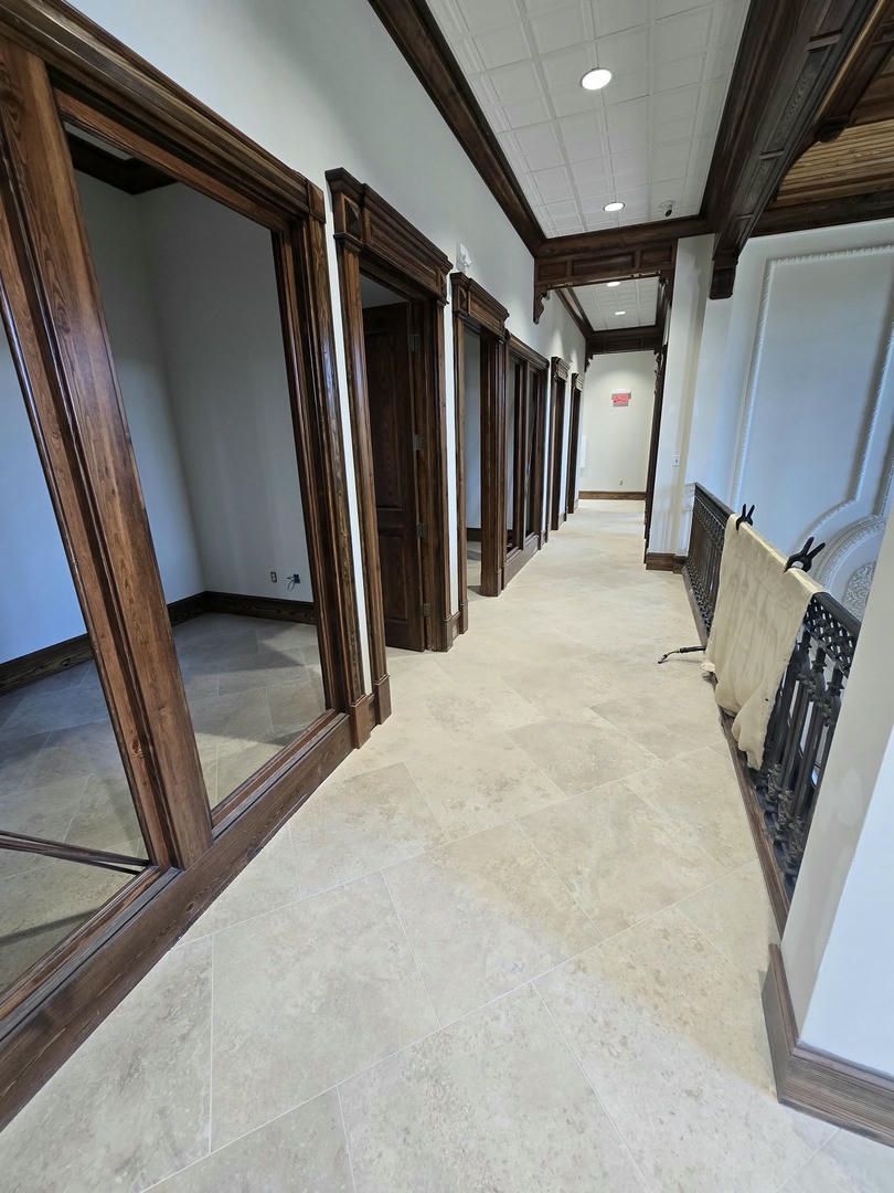 A long hallway with a lot of windows and doors