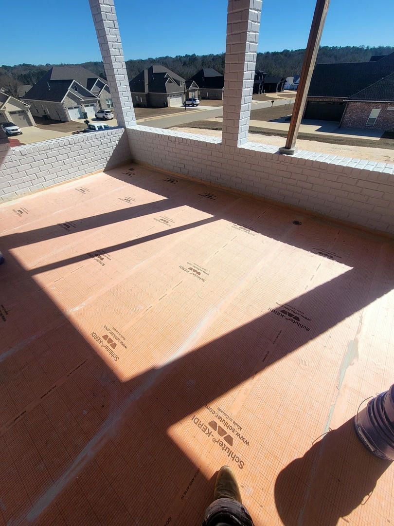 A person is standing in a room with a large window.