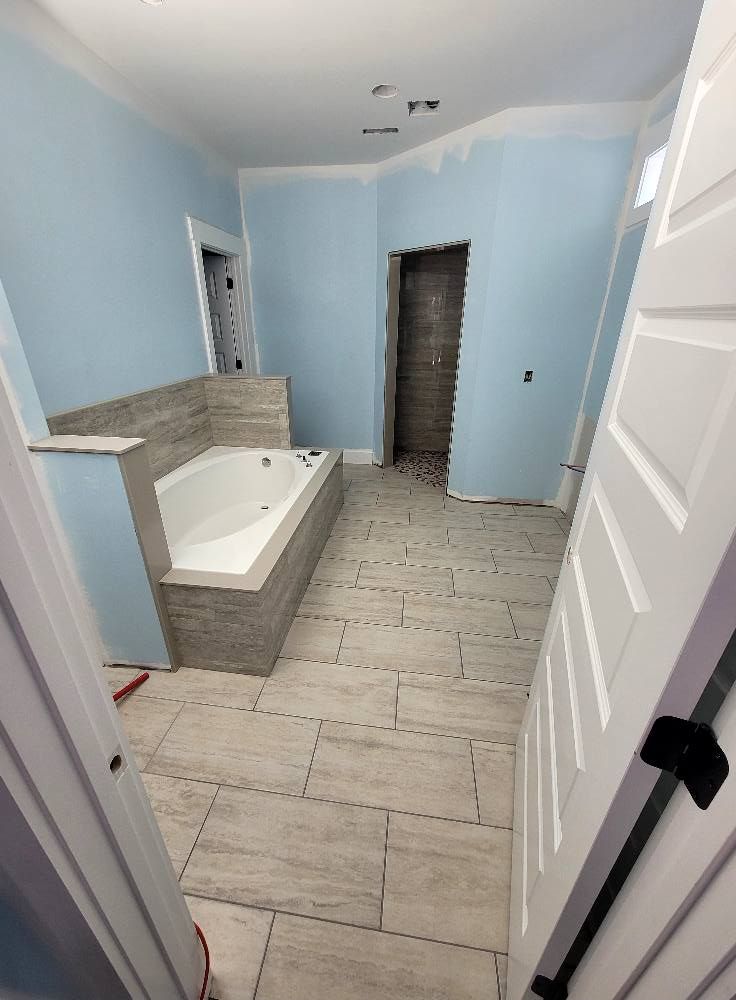 A bathroom with a bathtub and blue walls is being remodeled.