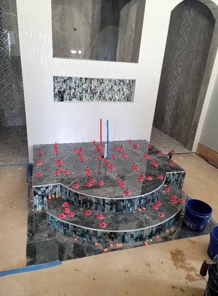 A clock is sitting on a tiled floor in a room.