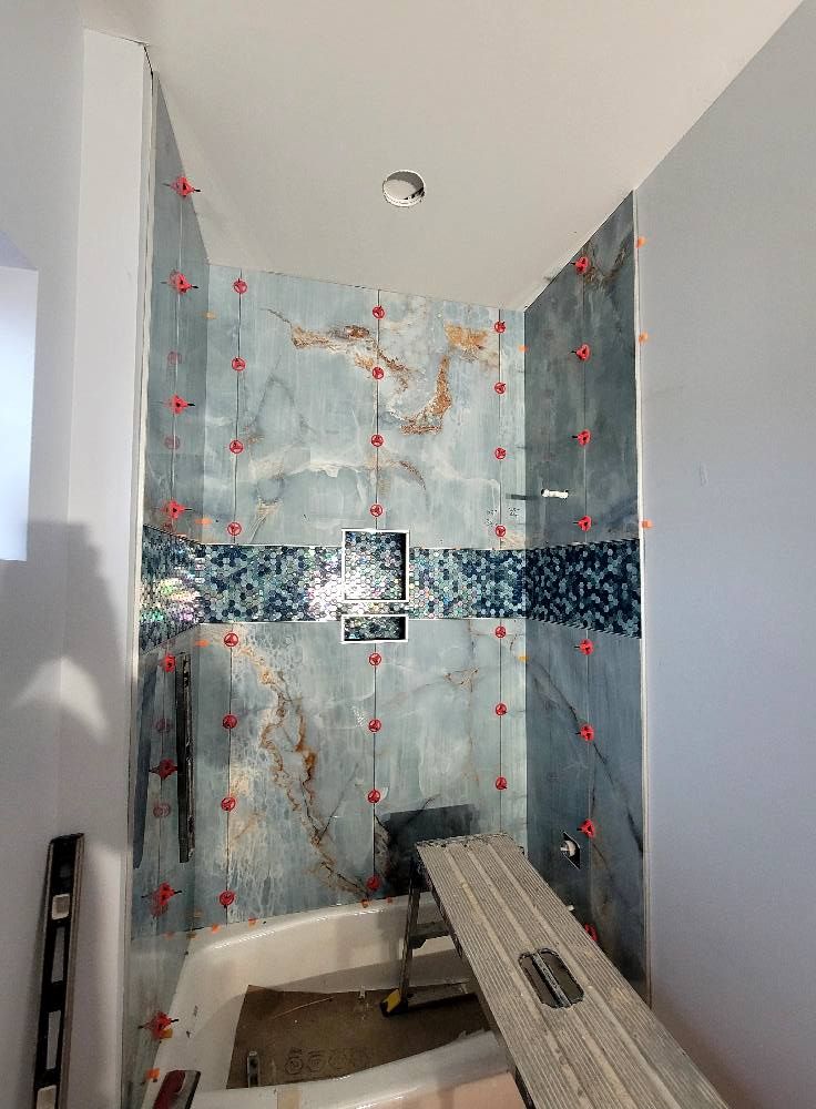 A bathroom with a tub and a shower being built.