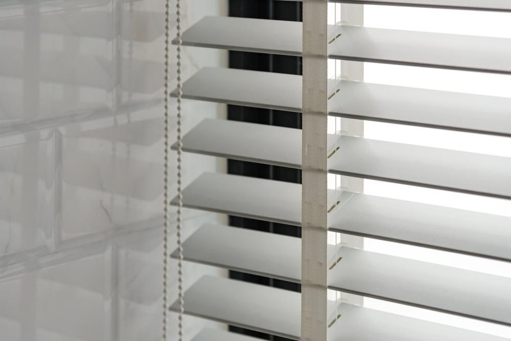 A Close Up Of White Venetian Blinds — Outdoor Blinds In Berkeley Vale, NSW