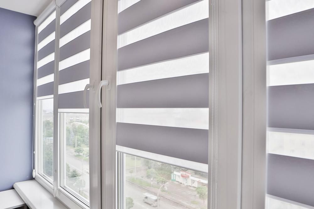 A Close Up Of A Window With Striped Blinds On It — Outdoor Blinds In Tuggerah, NSW