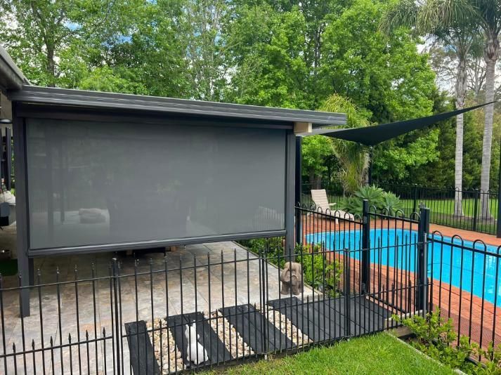 A House With A Fence And A Swimming Pool In The Backyard — Outdoor Blinds In Berkeley Vale, NSW