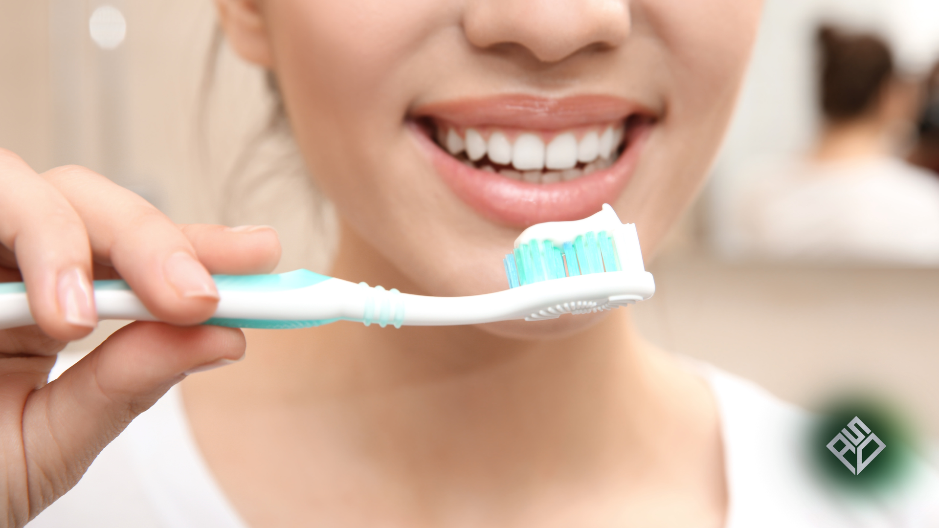 Woman brushing teeth with a green toothbrush, mouth open, white foam visible.