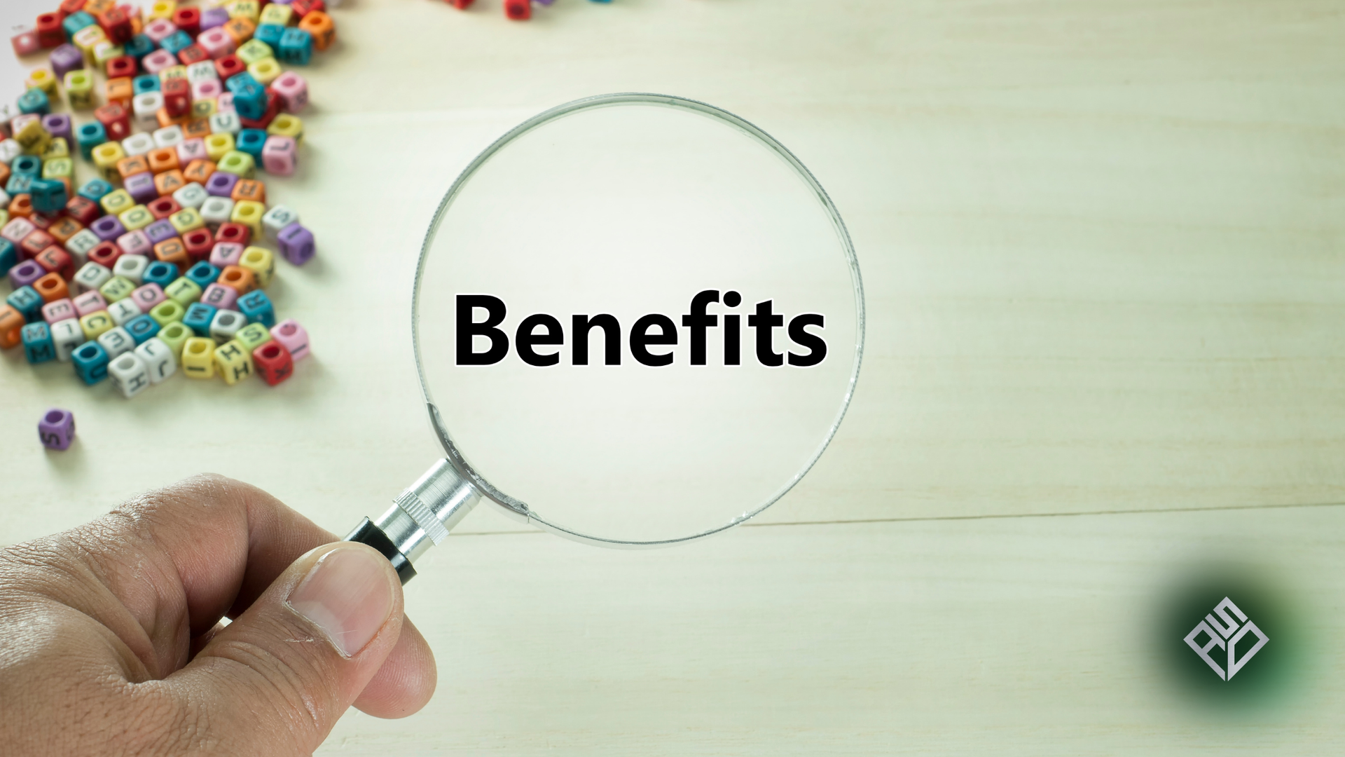 Hand holding magnifying glass over the word 