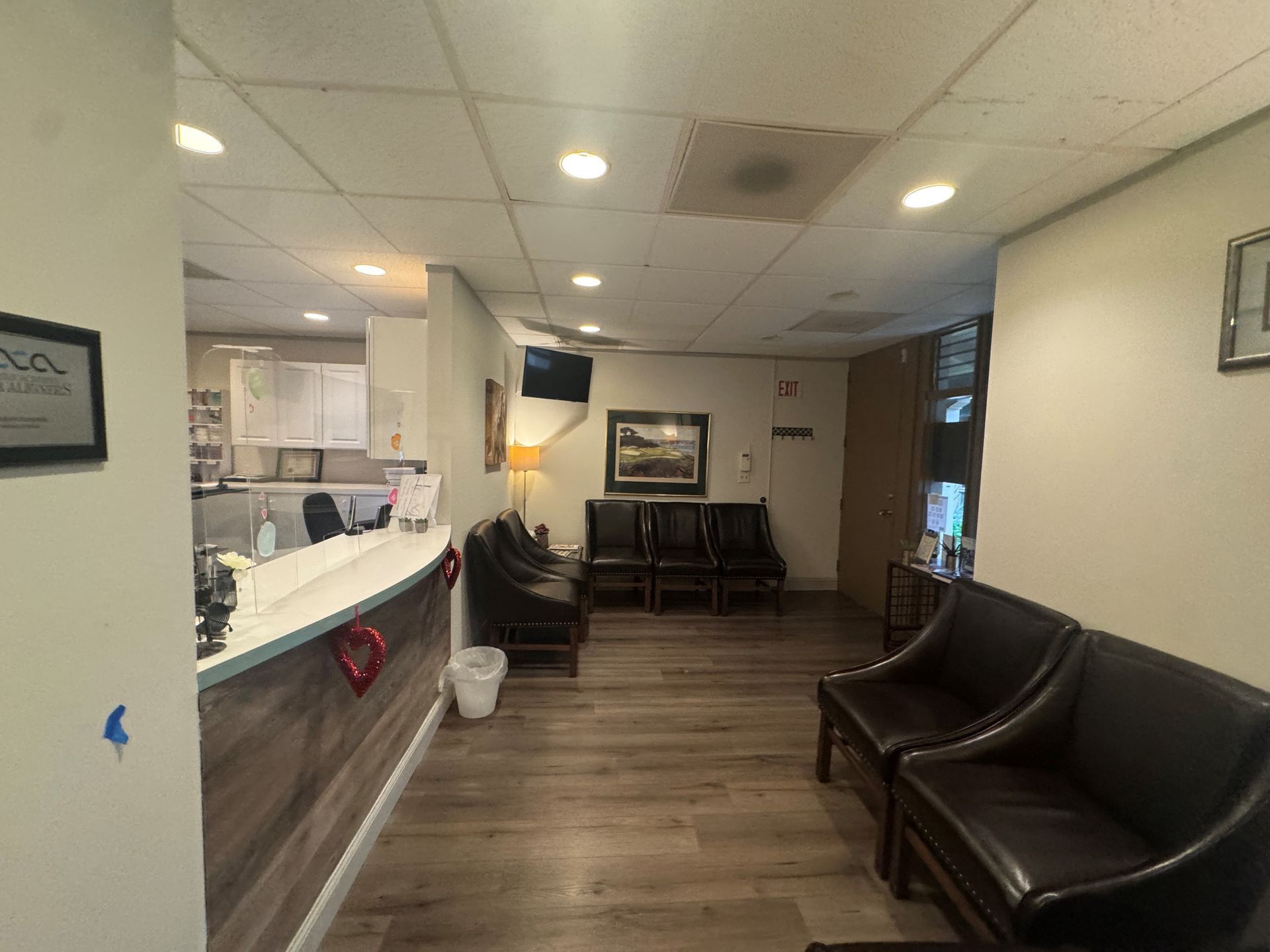 Amazing Smile Dental Reception area with a waiting area, desk, chairs, and art on the wall.