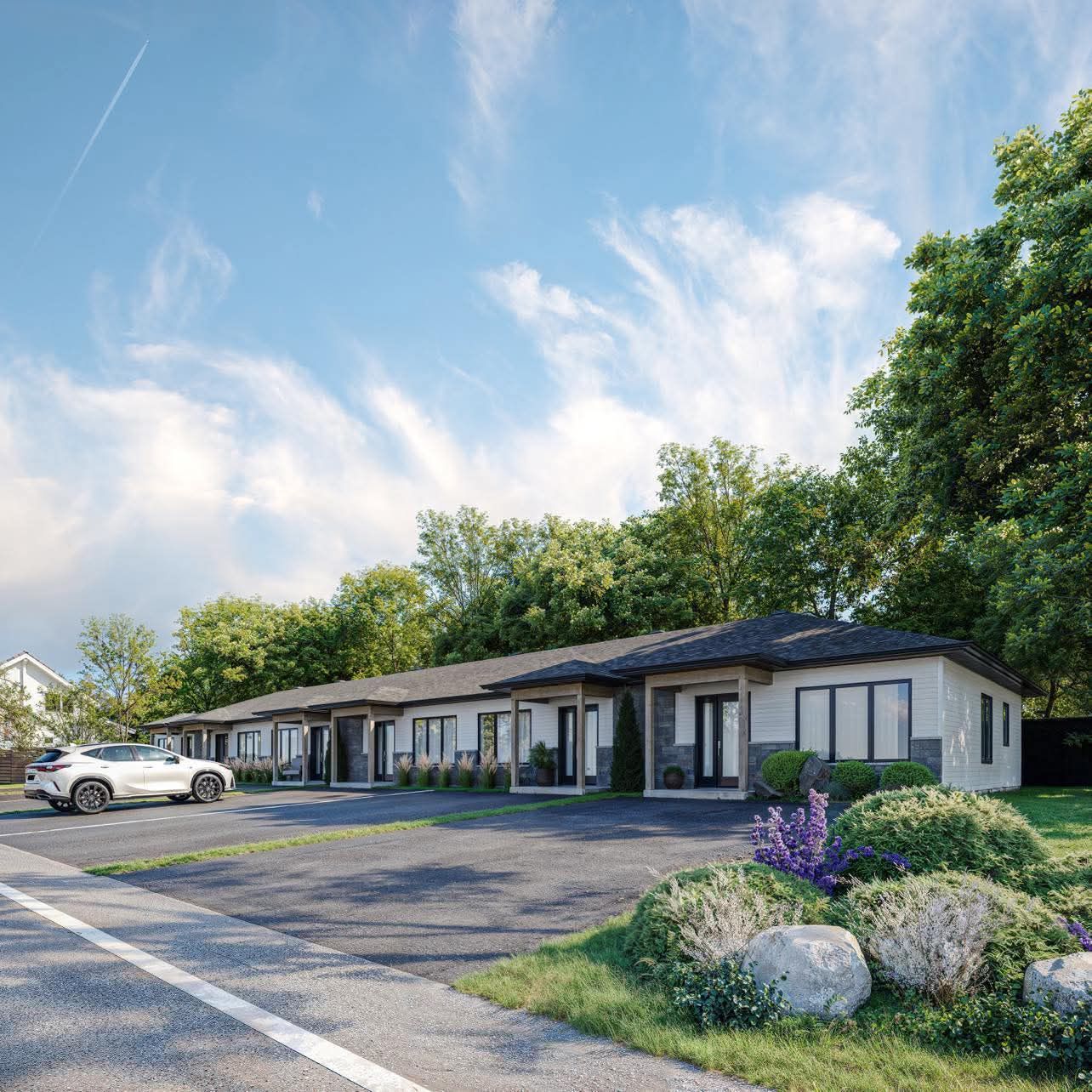 Une impression d'artiste d'une rangée de maisons avec des voitures garées devant elles.