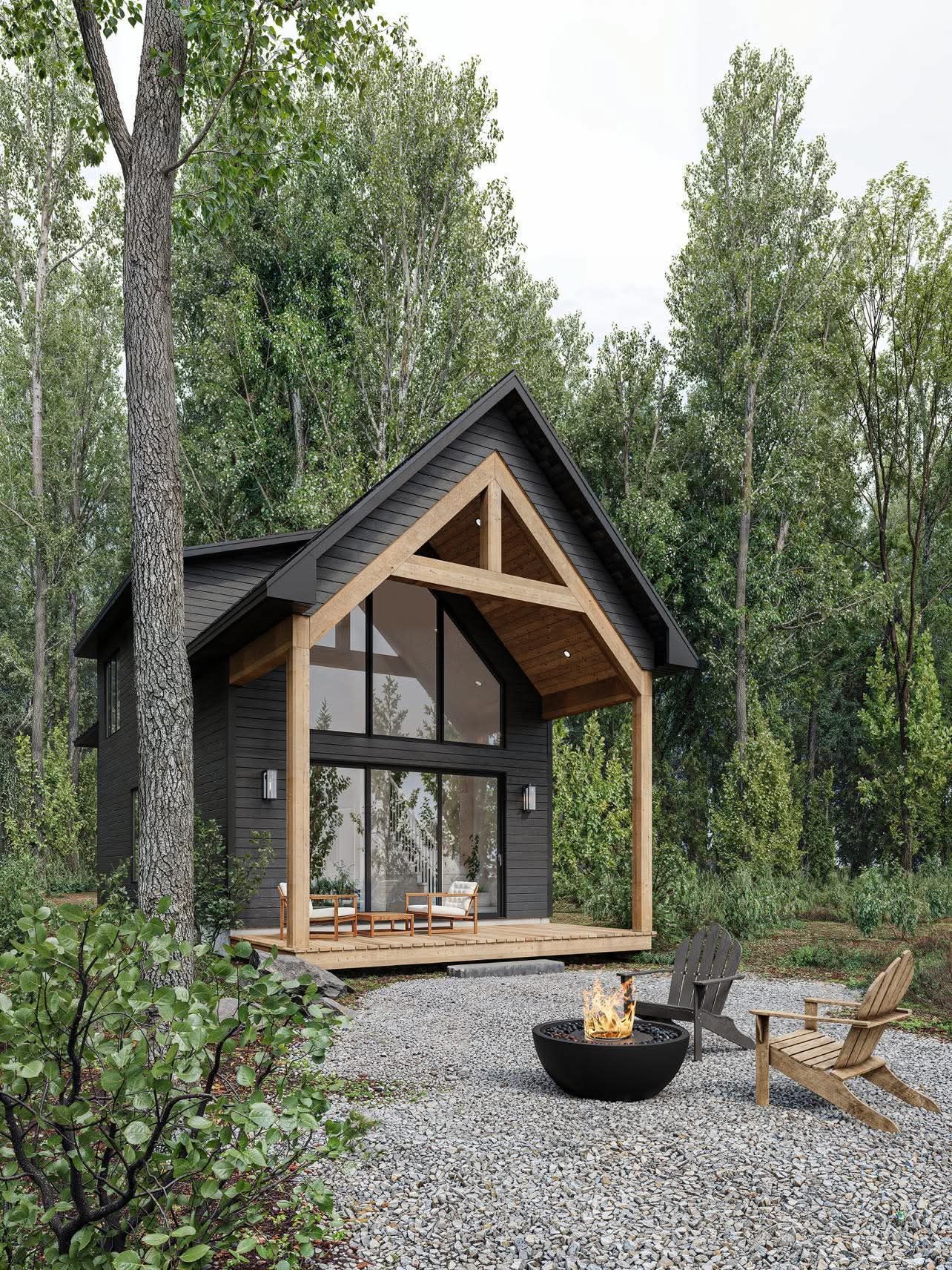 Une petite maison au milieu d'une forêt avec un foyer devant.