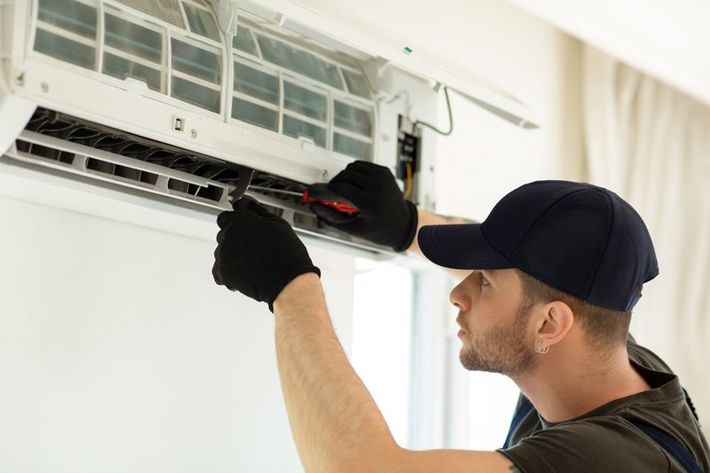 Technician Repairing The Air Condition - Destin, FL - Air Conditioning & Heating Solutions LLC