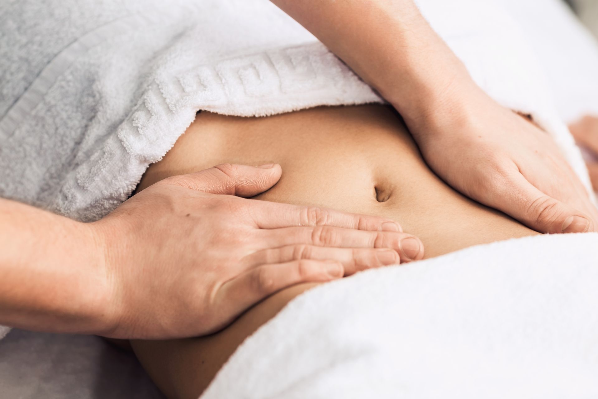 A woman is getting a massage on her stomach in a spa.