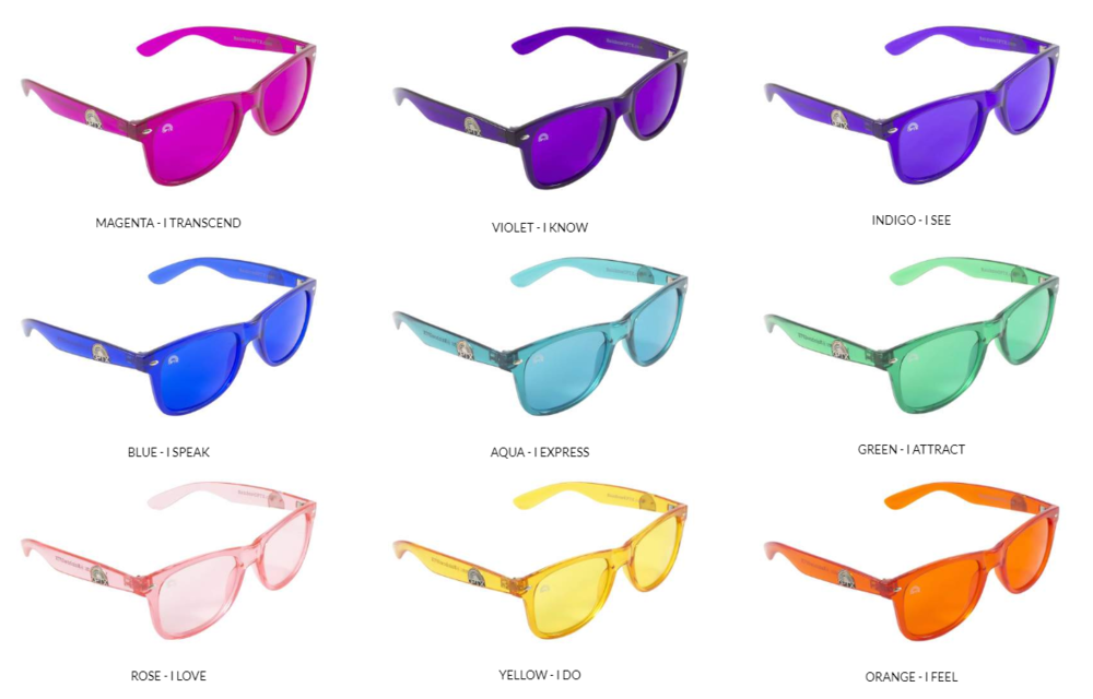 A bunch of different colored sunglasses on a white background