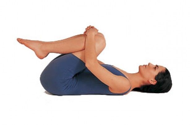 A woman is laying on her stomach with her legs crossed.