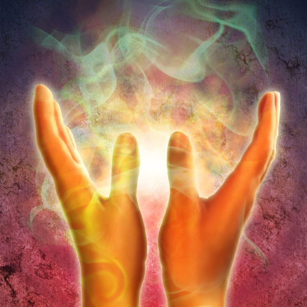 A pair of hands holding a light in their palms.