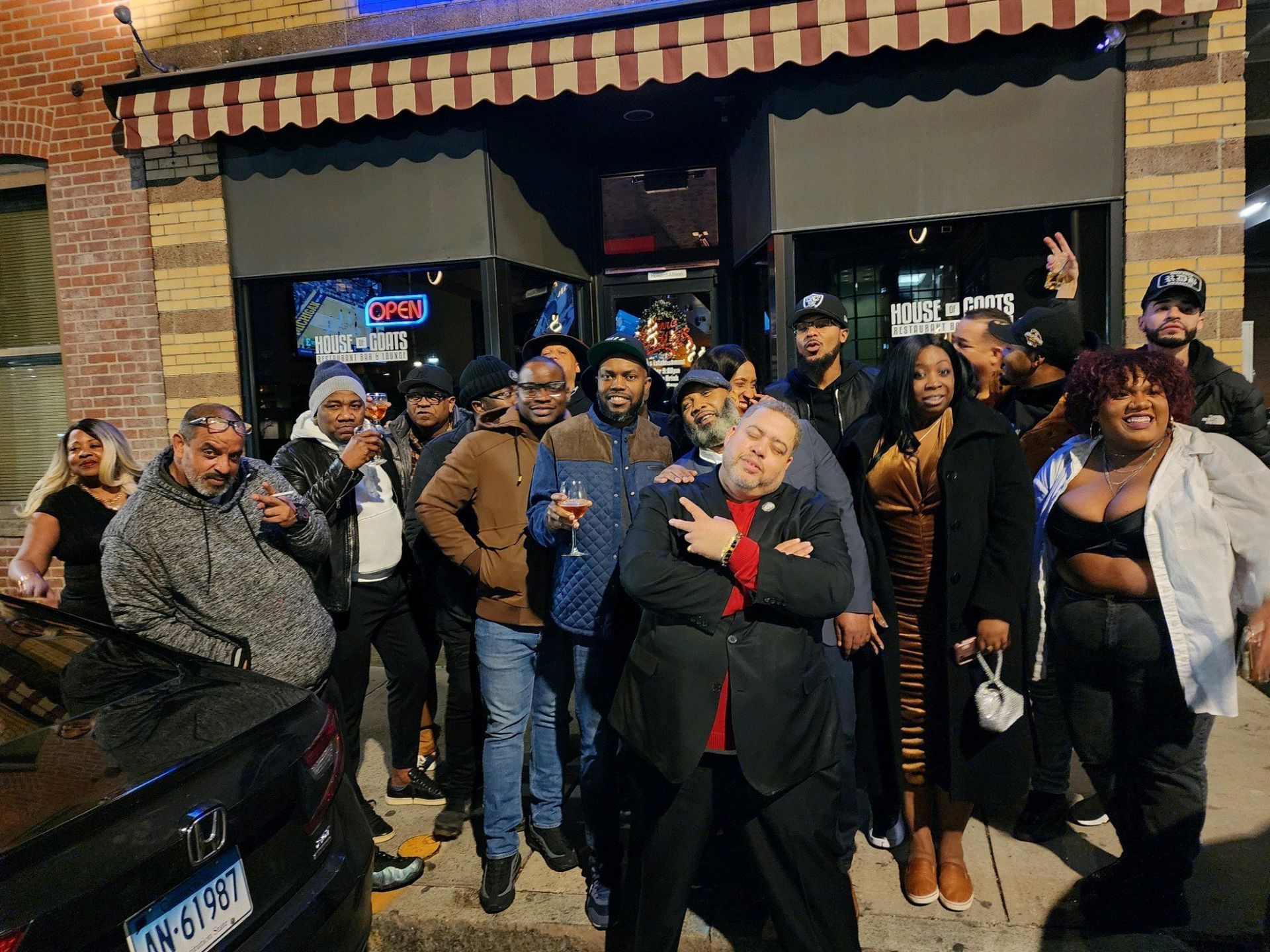 A group of people are posing for a picture in front of a building.