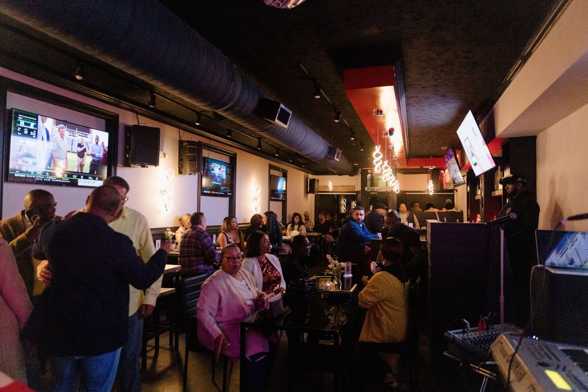 A group of people are sitting at tables in a restaurant