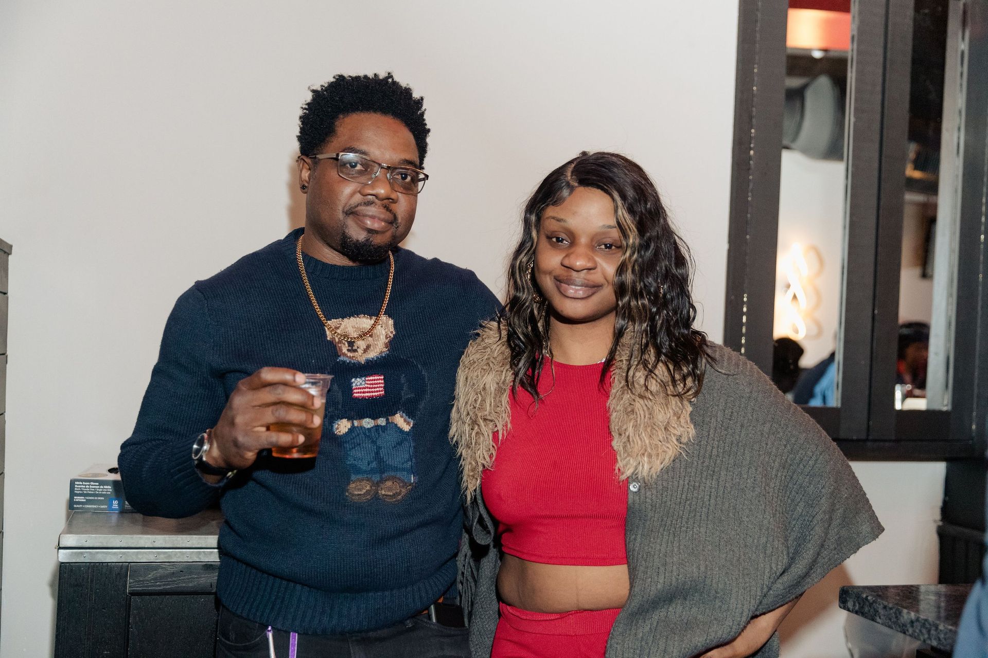 A man and a woman are posing for a picture in a room.