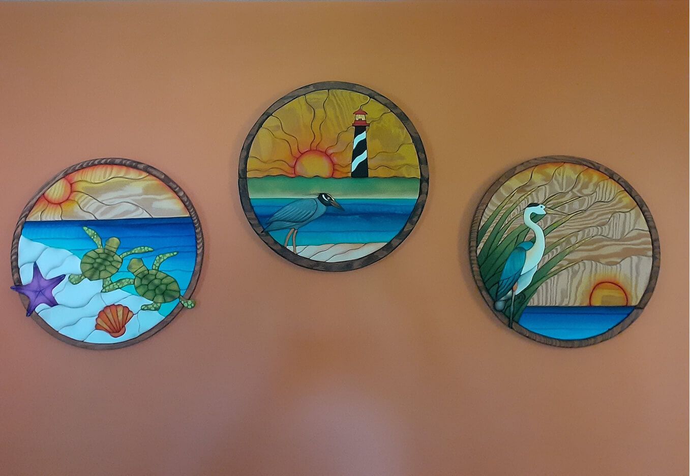 Intarsia art by Nick Vidakovic featuring scuba diver in reef, island sunset, and shells on the beach