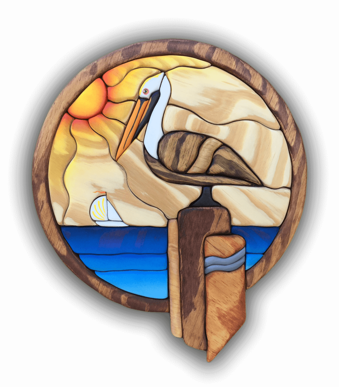 Intarsia Art by Nick Vidakovic of a pelican sitting on a wooden dock post with a sailboat and setting sun in the background
