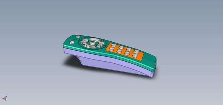 A green and orange remote control on a light purple base on a gray surface.