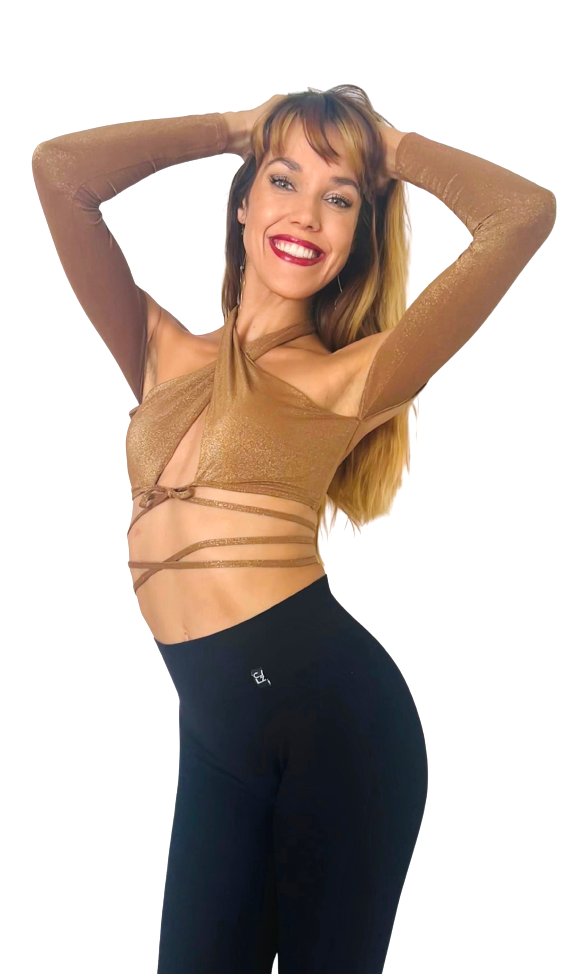 A woman in a white crop top and blue pants is standing with her hands on her hips.