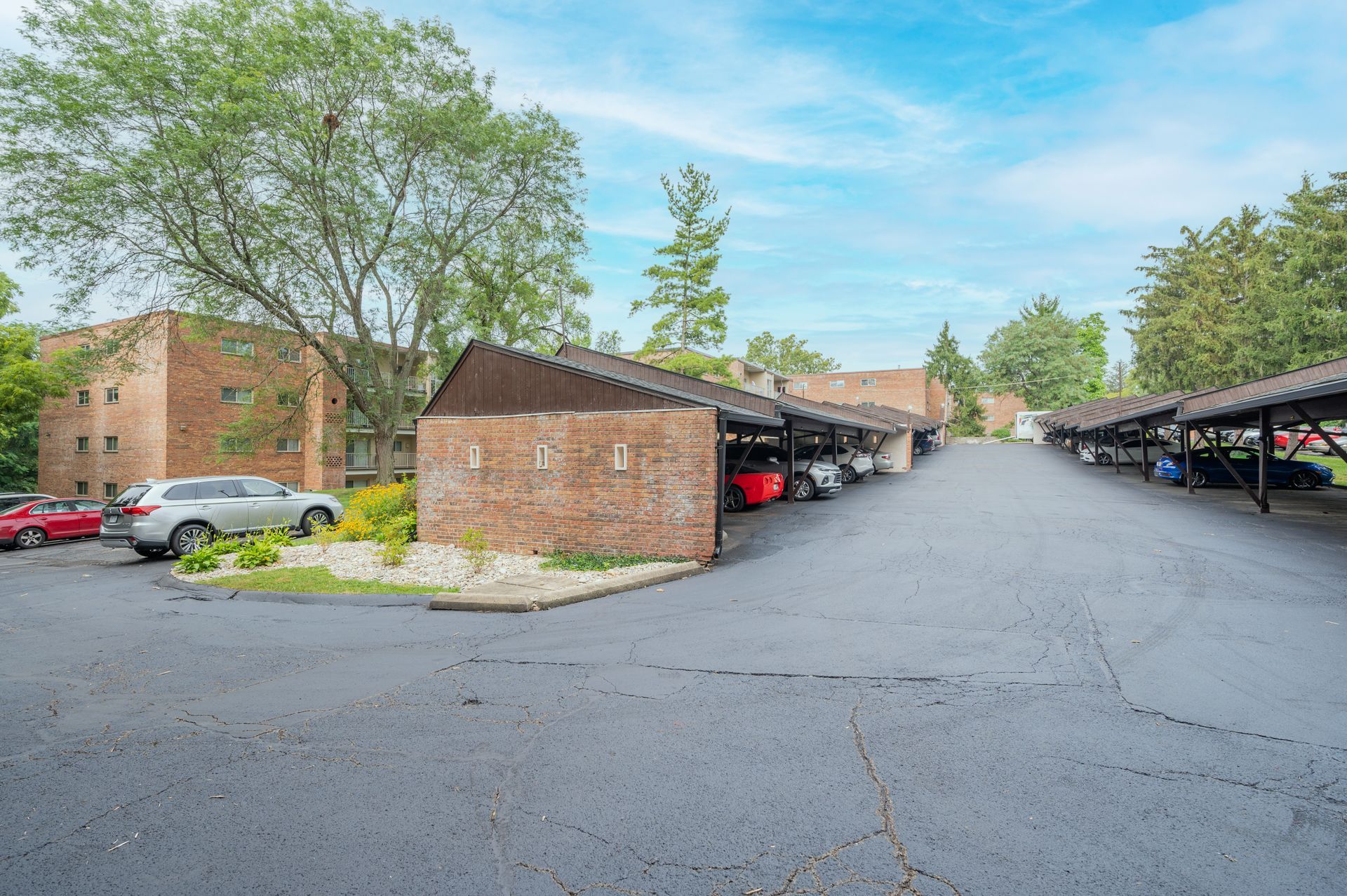 The Heritage at Wyoming apartment community with covered parking and brick buildings.