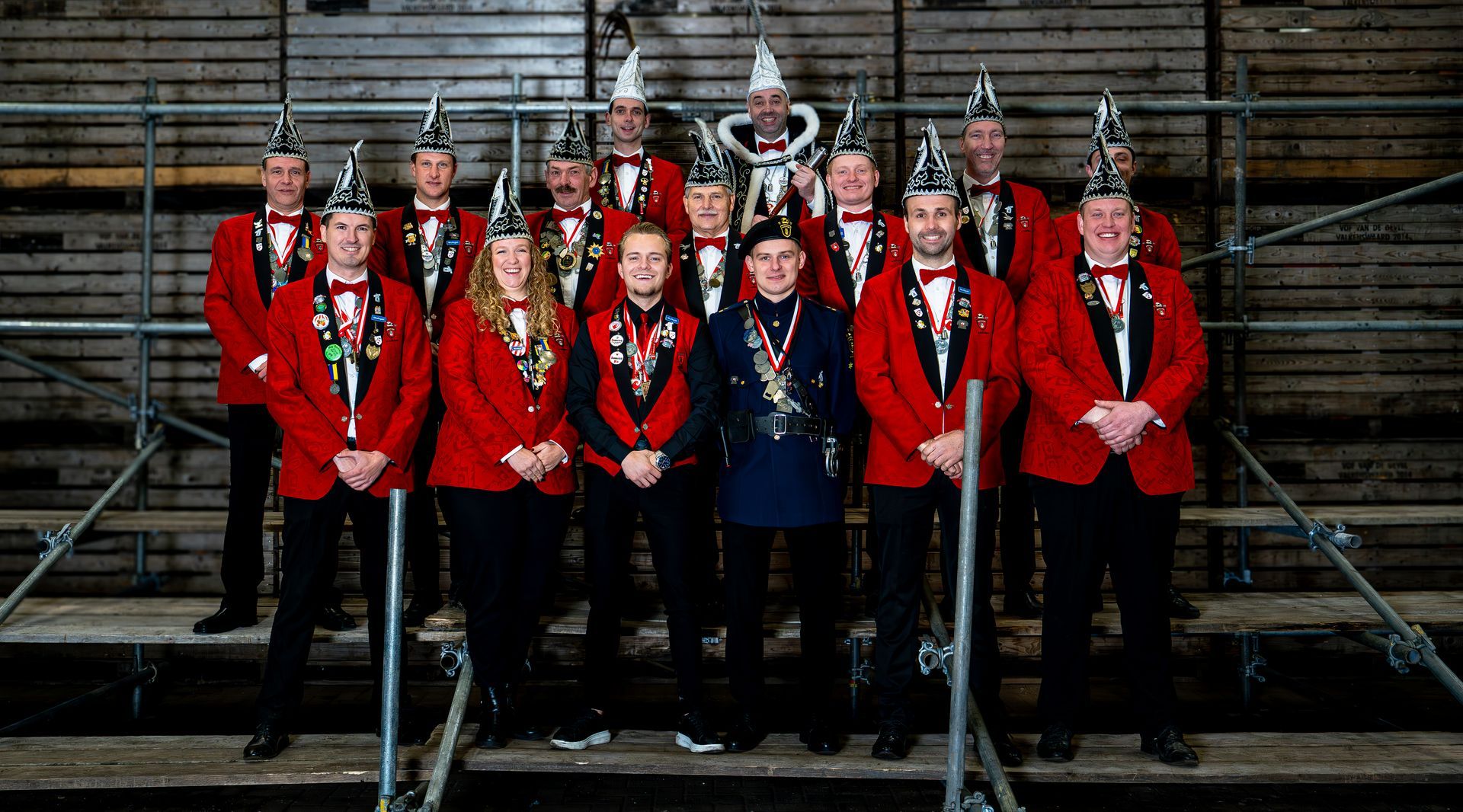 Een groep mannen poseert voor een foto voor een gebouw.
