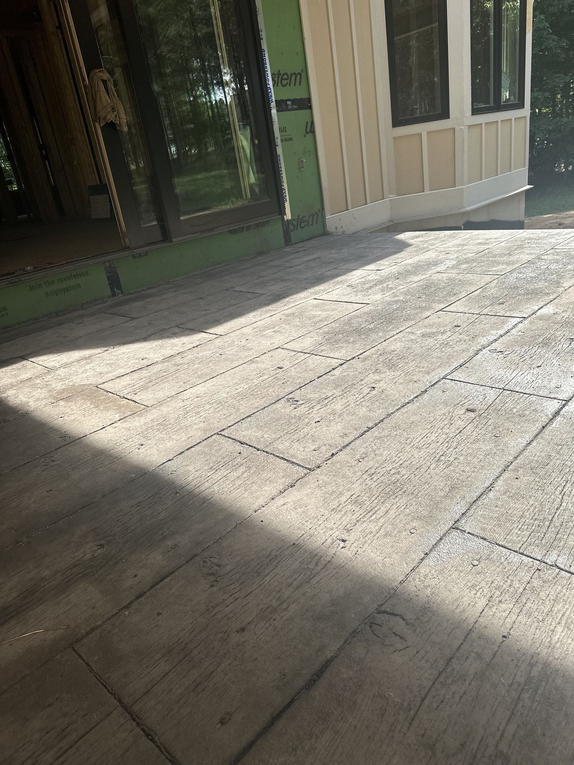 A concrete floor in front of a building under construction.