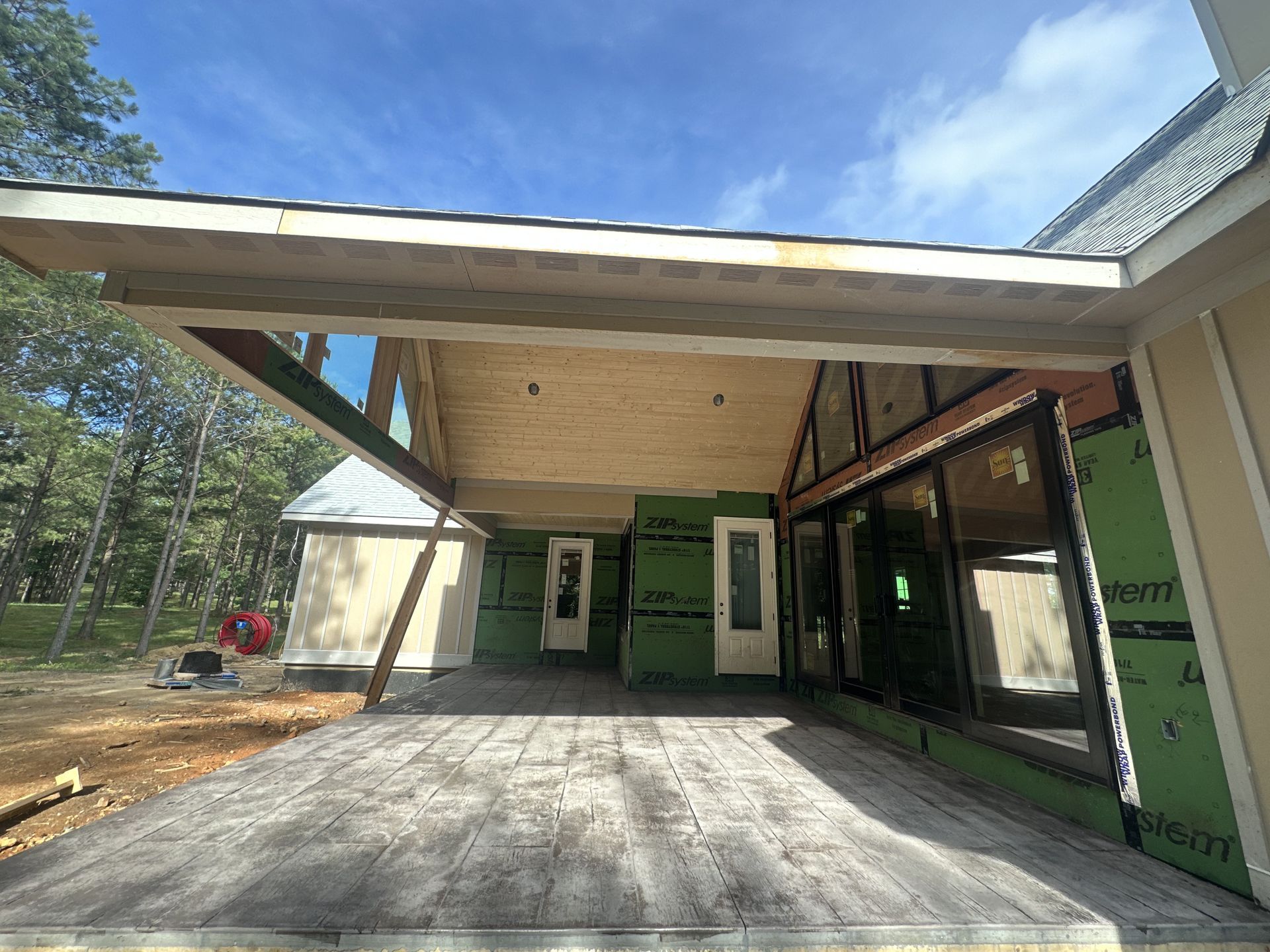 A house is being built with a large covered porch.
