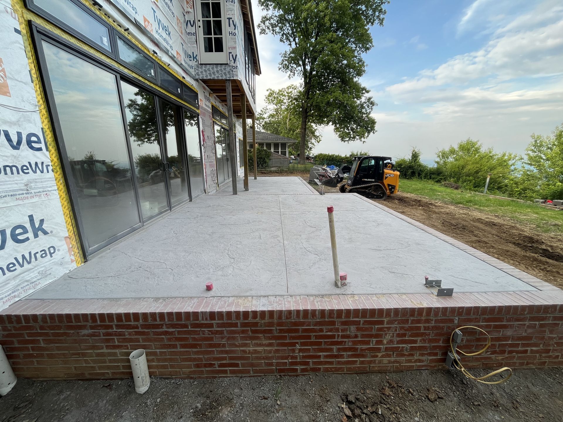 A brick building with a concrete patio in front of it.