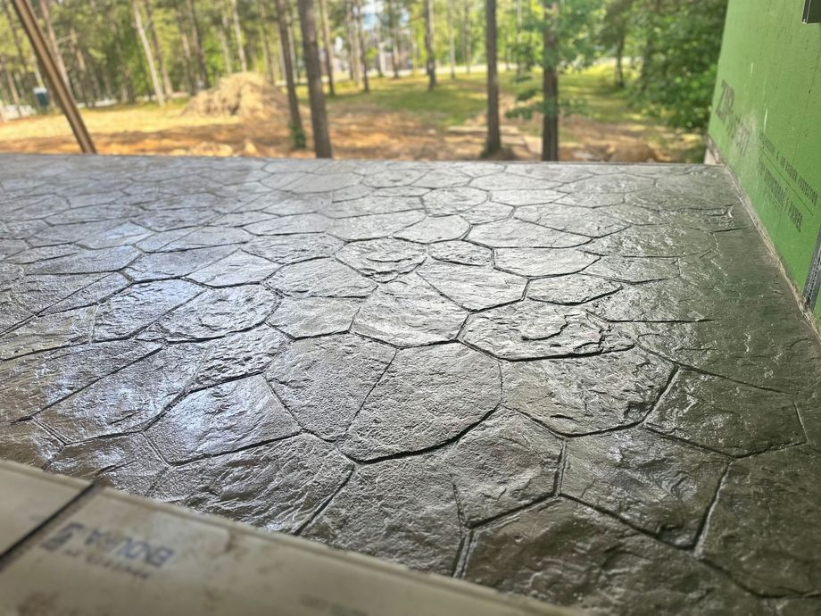 A close up of a concrete floor with trees in the background.